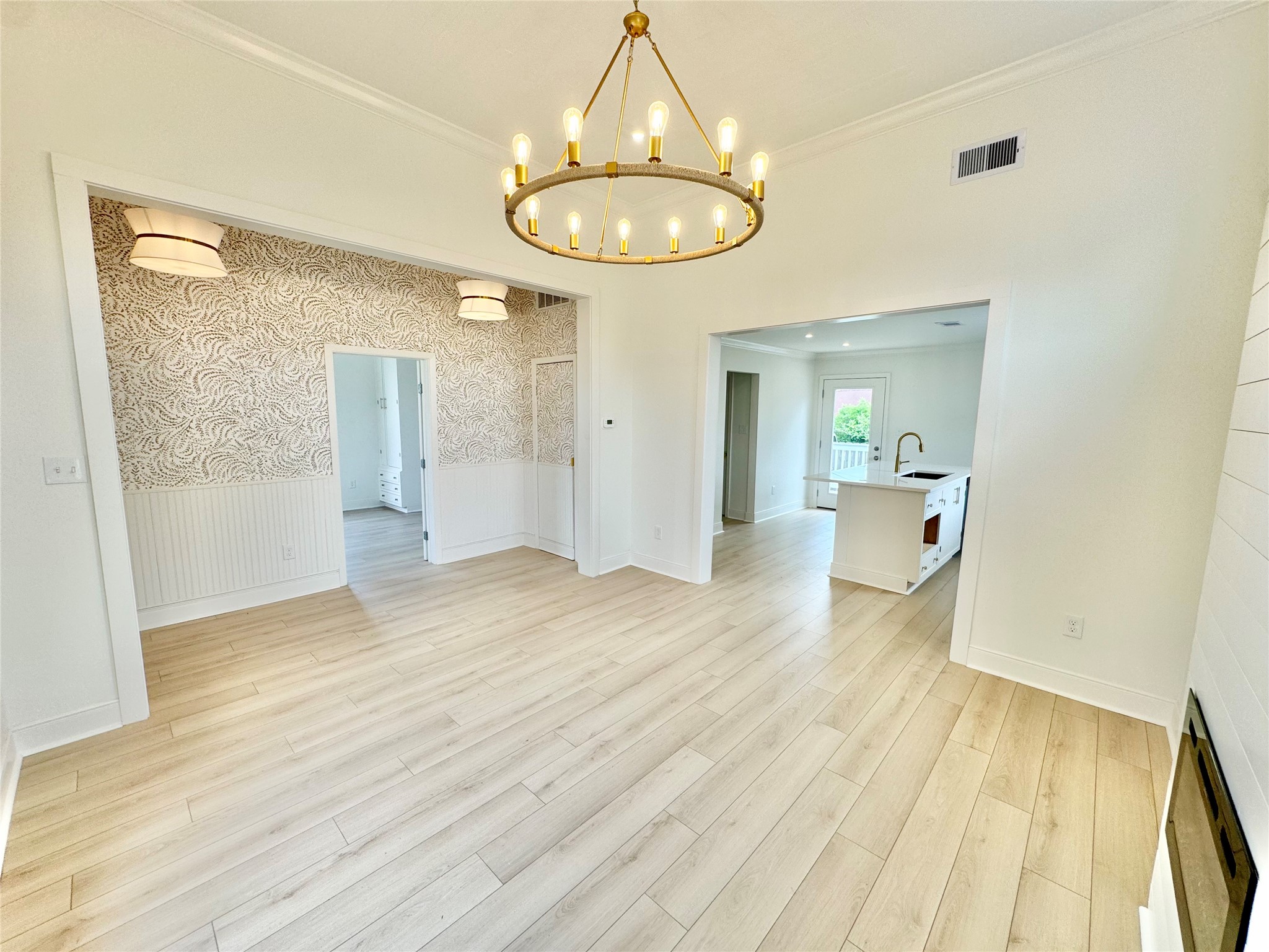1312 35th Street Galveston, TX 77550 - Photo 8 of 32 wooden floor in an empty room with a mirror