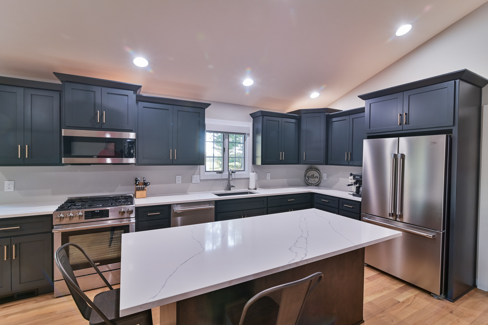 9220 Heritage Road Clinton, IL 61727 - Photo 12 of 37 a kitchen with stainless steel appliances a sink a stove a refrigerator cabinets and chairs