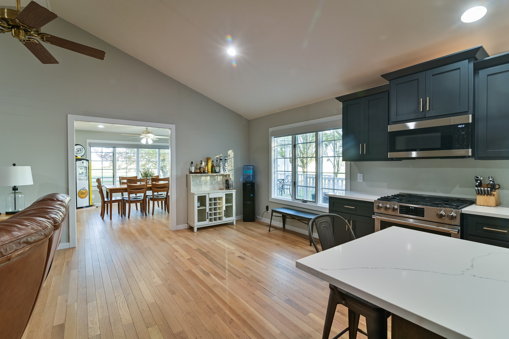 9220 Heritage Road Clinton, IL 61727 - Photo 15 of 37 a kitchen with stainless steel appliances wooden floors stove dining table and chairs