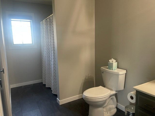 9220 Heritage Road Clinton, IL 61727 - Photo 20 of 37 a white toilet sitting next to a small bathroom