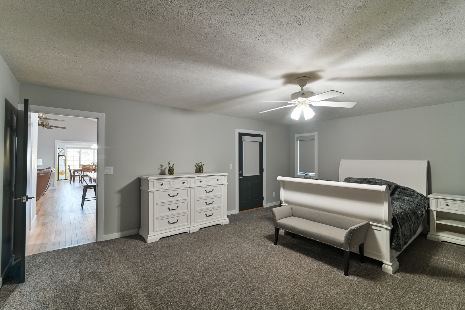 9220 Heritage Road Clinton, IL 61727 - Photo 23 of 37 a spacious bedroom with a bed and a chandelier