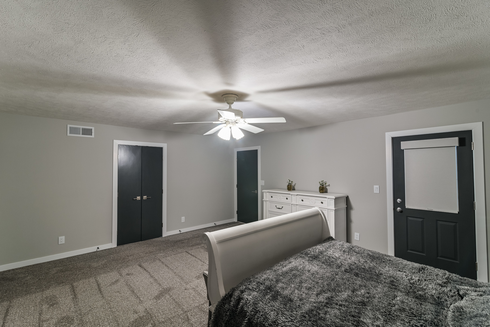9220 Heritage Road Clinton, IL 61727 - Photo 24 of 37 a bedroom with a bed and a chandelier