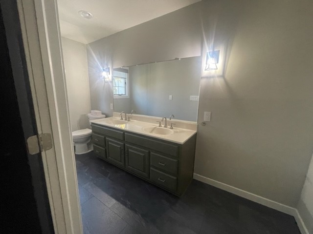 9220 Heritage Road Clinton, IL 61727 - Photo 25 of 37 a bathroom with a double vanity sink and a mirror