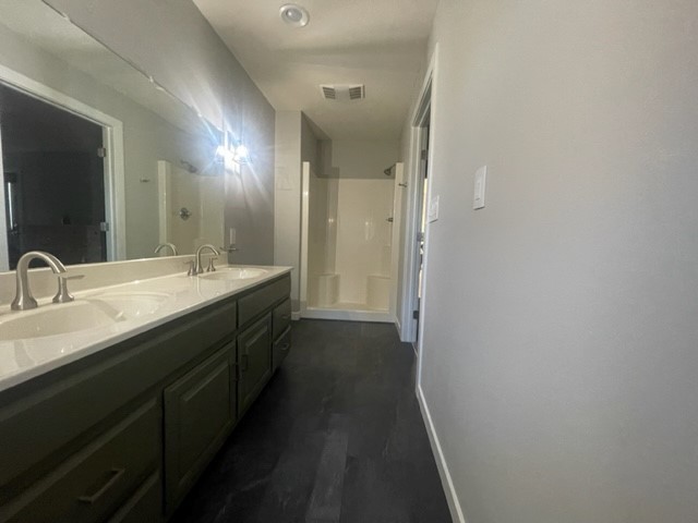 9220 Heritage Road Clinton, IL 61727 - Photo 26 of 37 a bathroom with a double vanity sink and a mirror