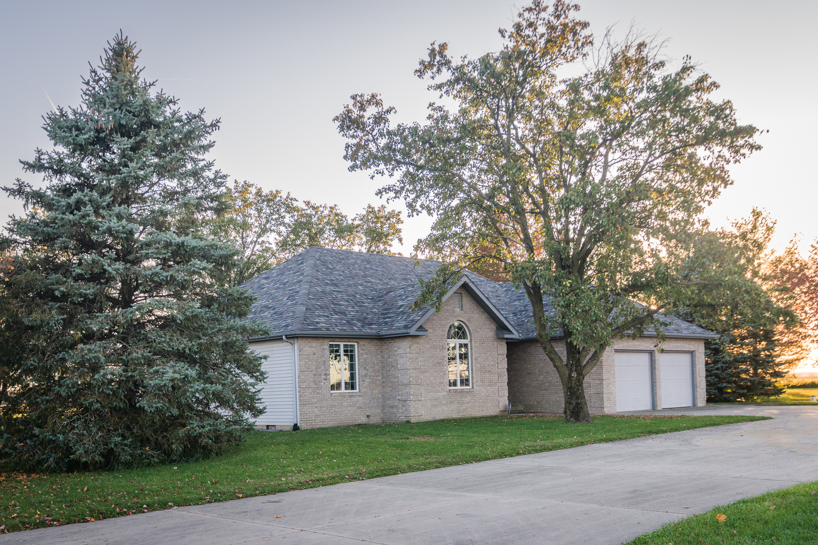 9220 Heritage Road Clinton, IL 61727 - Photo 9 of 37 a front view of a house with a garden and trees