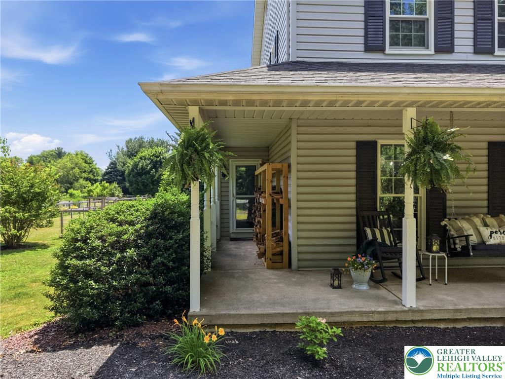 890 Lahr Road Nazareth, PA 18064 - Photo 66 of 71 A welcoming front porch beckons with its charming swing and lush hanging plants.