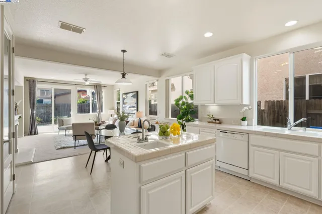 a kitchen with sink refrigerator and dining table