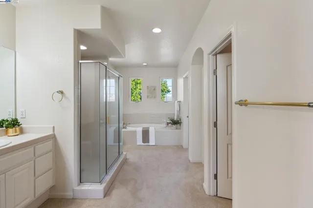 a bathroom with a granite countertop sink a toilet and shower