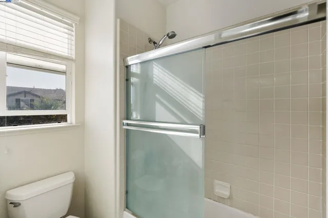 a bathroom with a shower and toilet