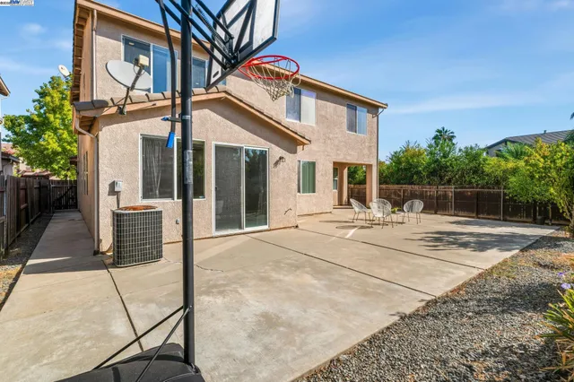 a view of a house with basketball court
