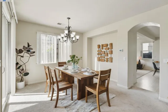 a view of a dining room with furniture and chandelier