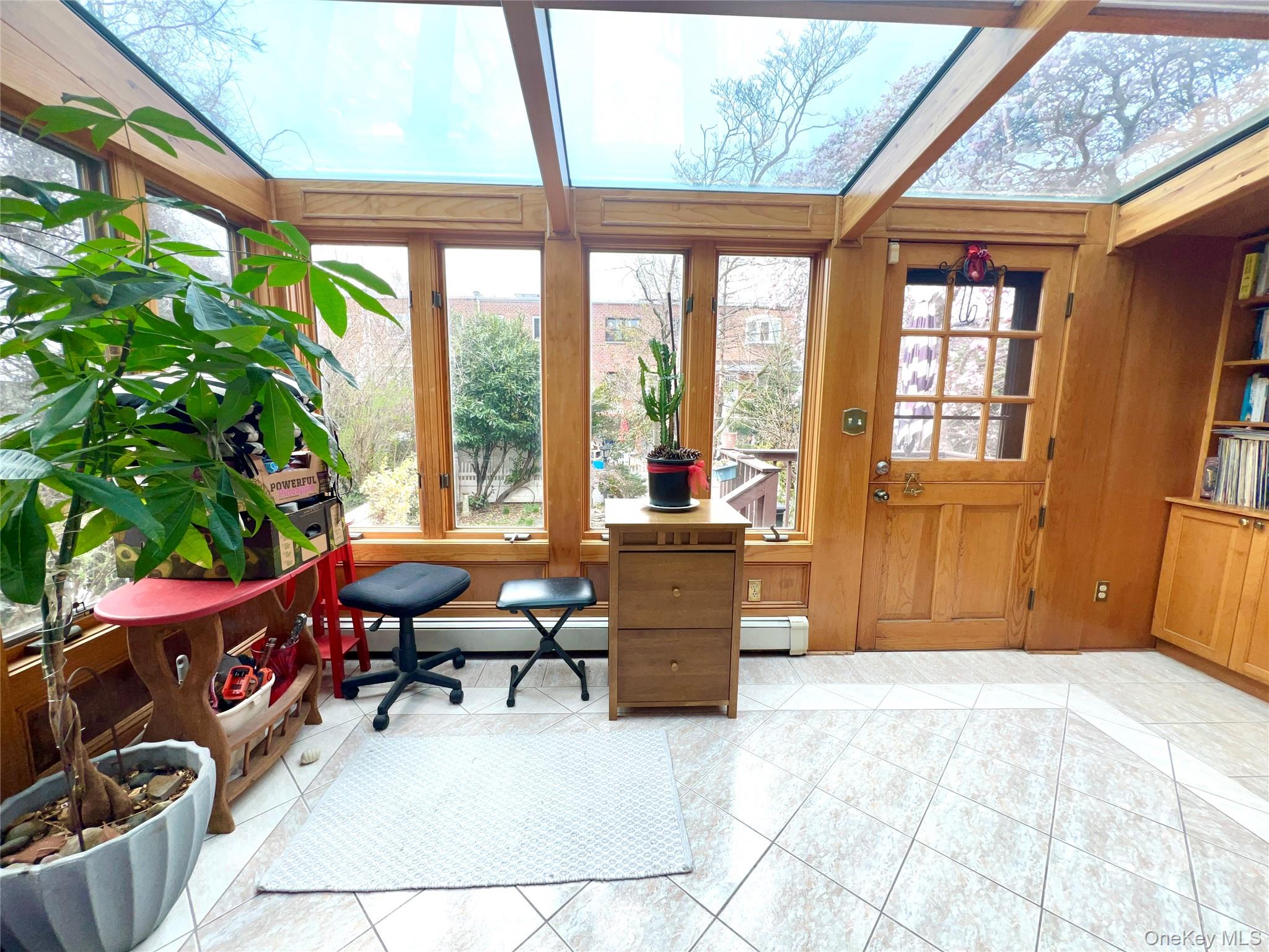 2561 Eastchester Road Bronx, NY 10469 - Photo 12 of 13 a living room with furniture and a large window
