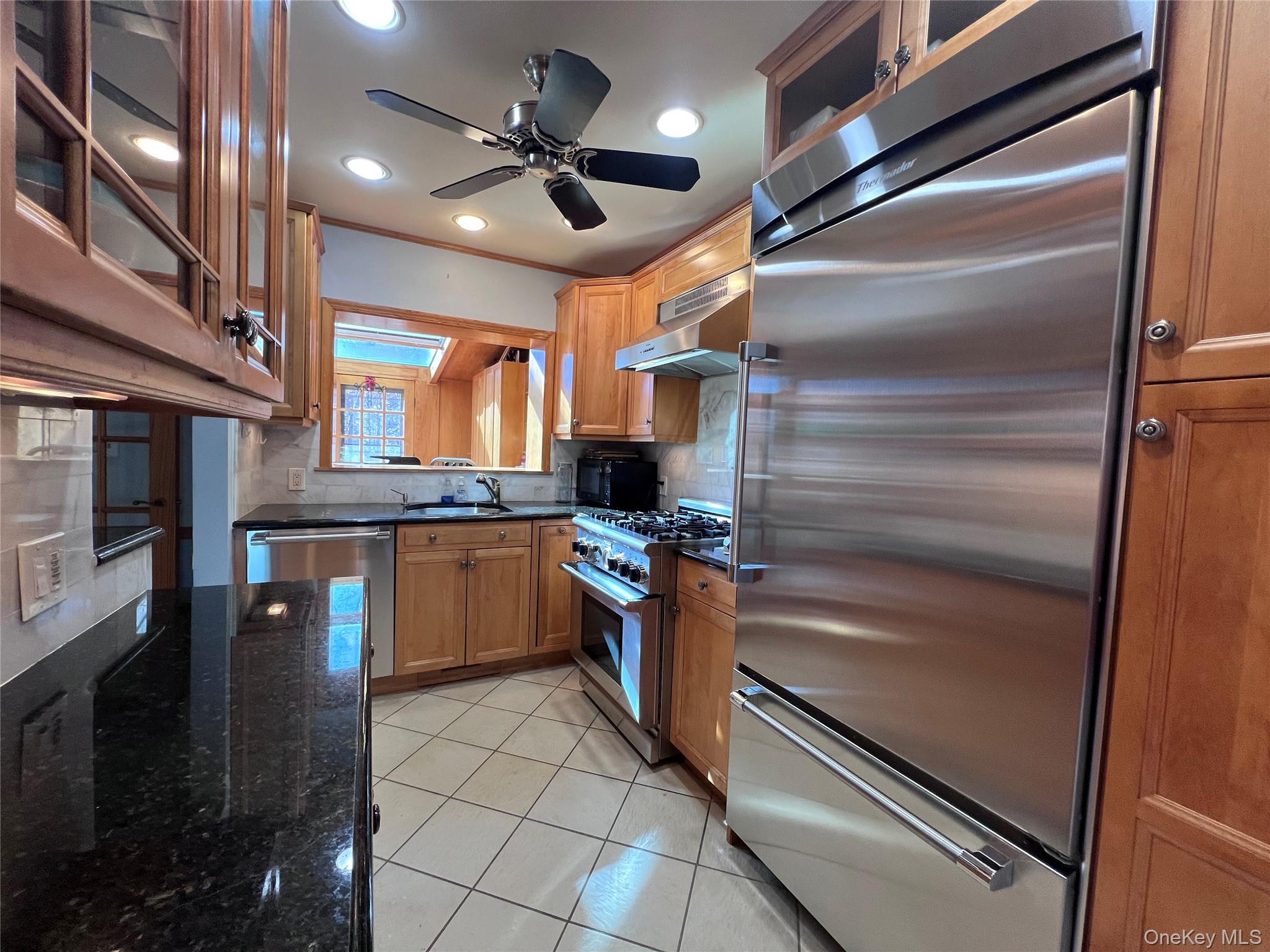 2561 Eastchester Road Bronx, NY 10469 - Photo 4 of 13 a kitchen with a refrigerator and a sink