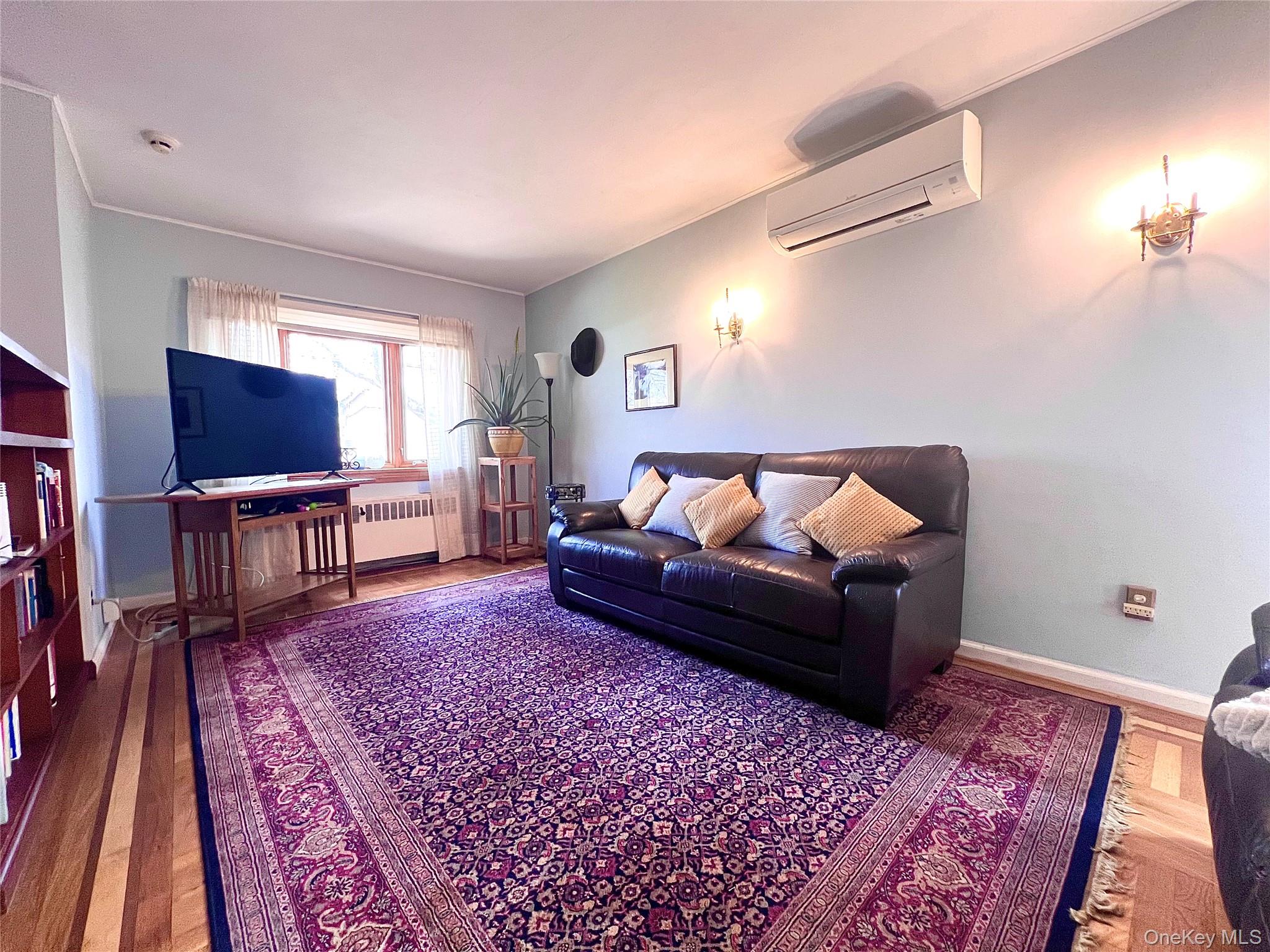 2561 Eastchester Road Bronx, NY 10469 - Photo 5 of 13 a living room with furniture and a rug