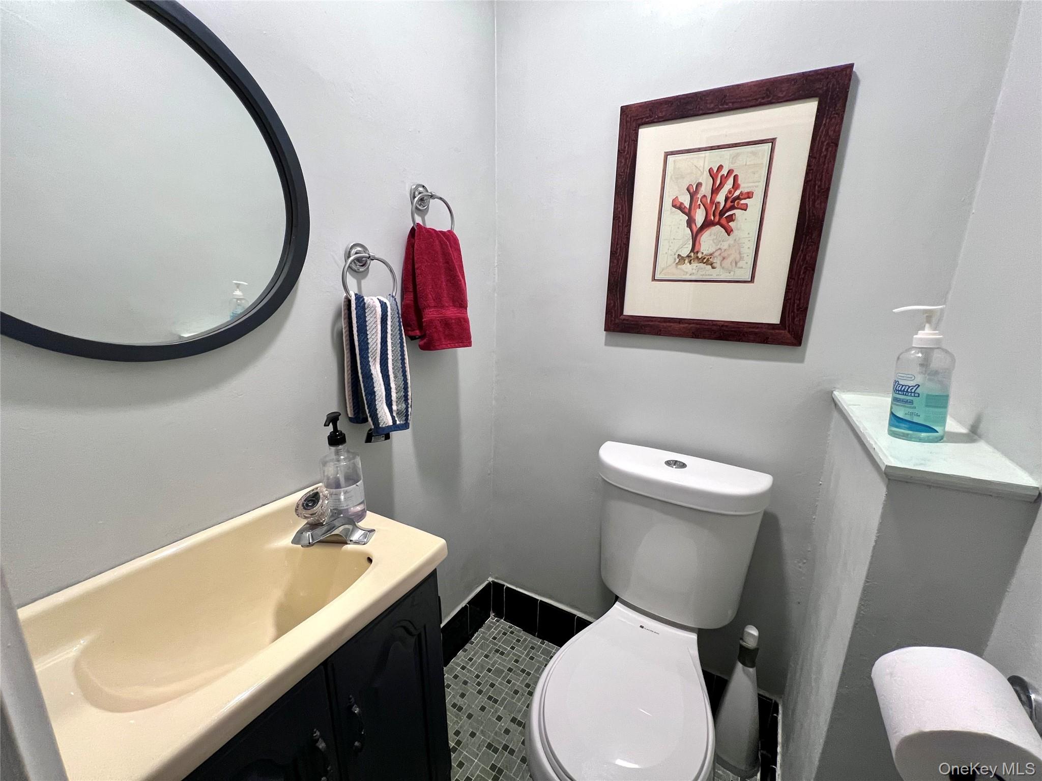 2561 Eastchester Road Bronx, NY 10469 - Photo 7 of 13 a bathroom with a toilet a sink and a mirror