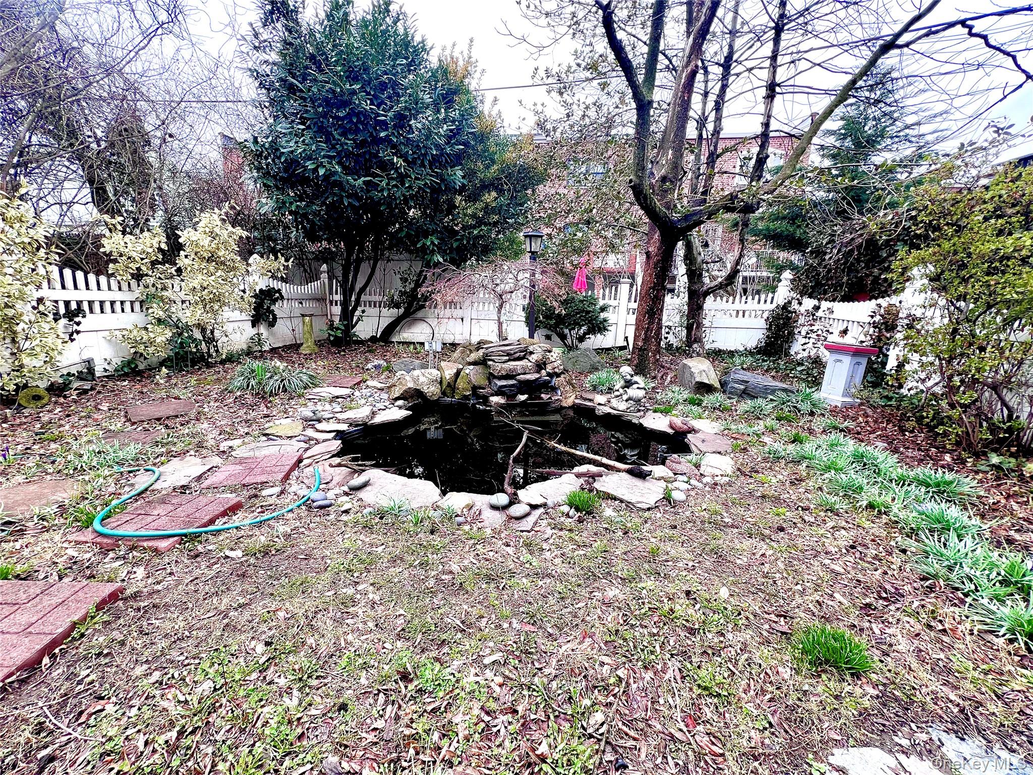 2561 Eastchester Road Bronx, NY 10469 - Photo 9 of 13 a backyard of a house with lots of green space