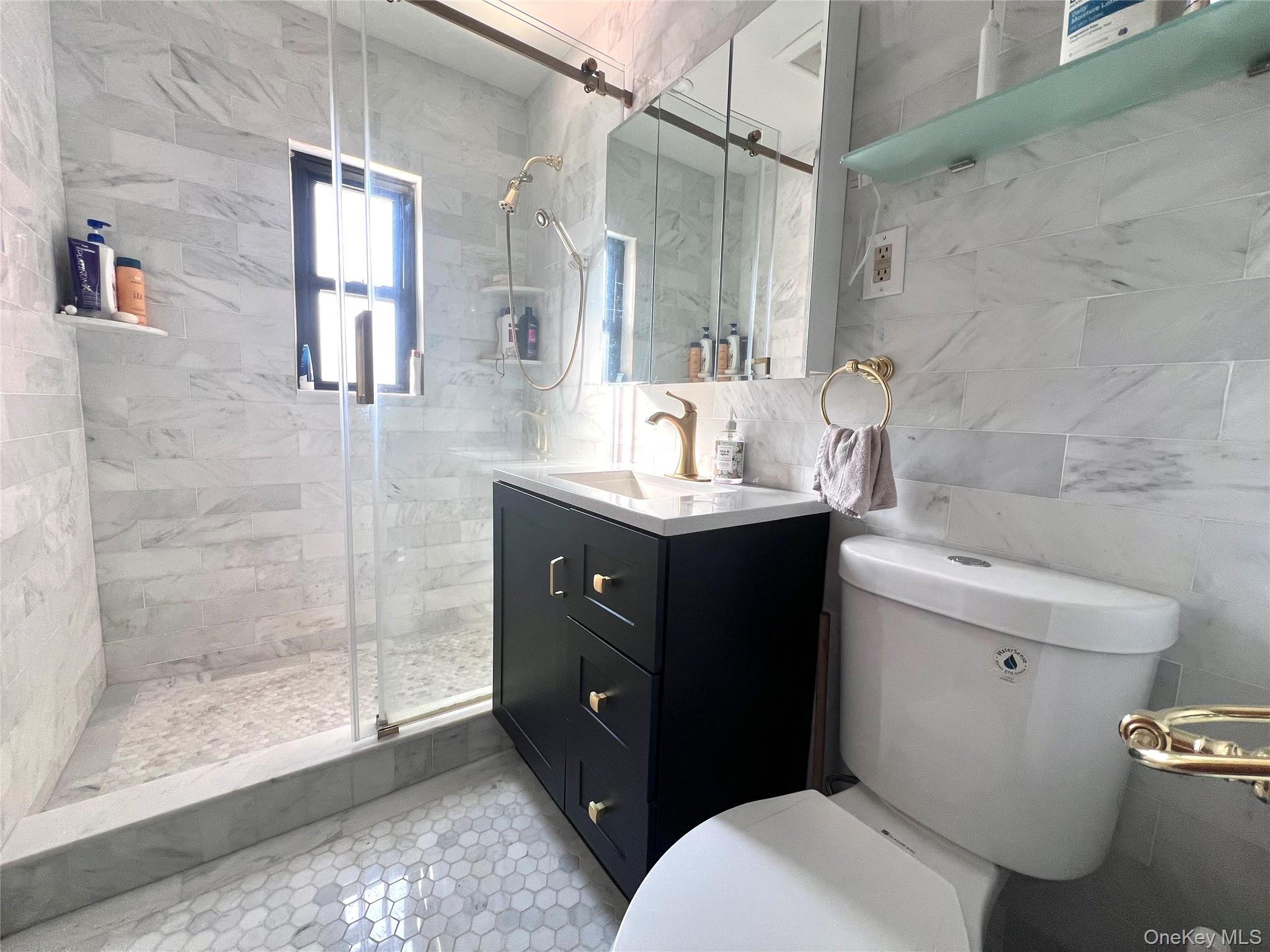 2561 Eastchester Road Bronx, NY 10469 - Photo 10 of 13 a bathroom with a sink and mirror with toilet