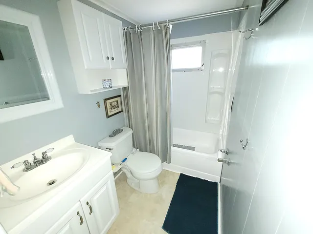 a kitchen with granite countertop a sink a stove and cabinets