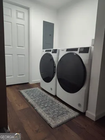 a bedroom with a bed and dresser with mirror