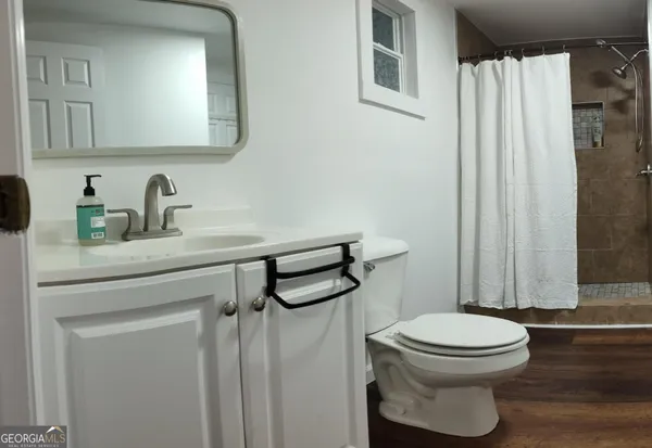 a white toilet sitting next to a bathroom sink