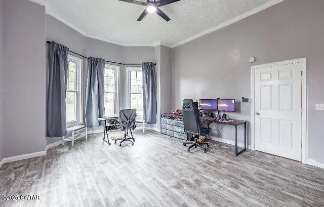 a view of a workspace with furniture and a window