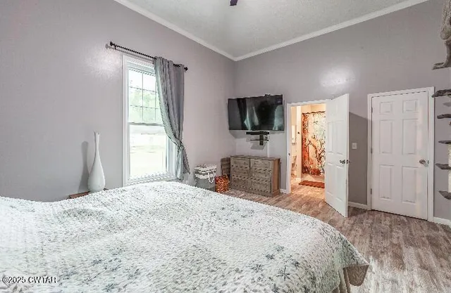 a bedroom with a bed and a flat screen tv