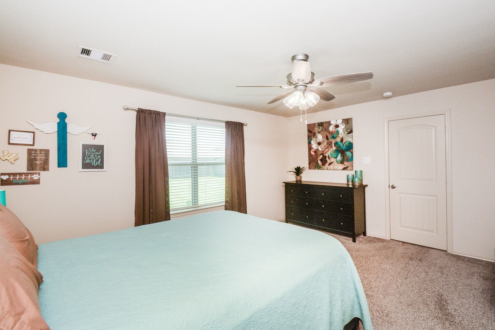 23318 Dukes Run Drive Spring, TX 77373 - Photo 26 of 41 This is a cozy bedroom featuring neutral walls, a ceiling fan, and carpeted flooring. It includes a large window, allowing natural light to fill the space.