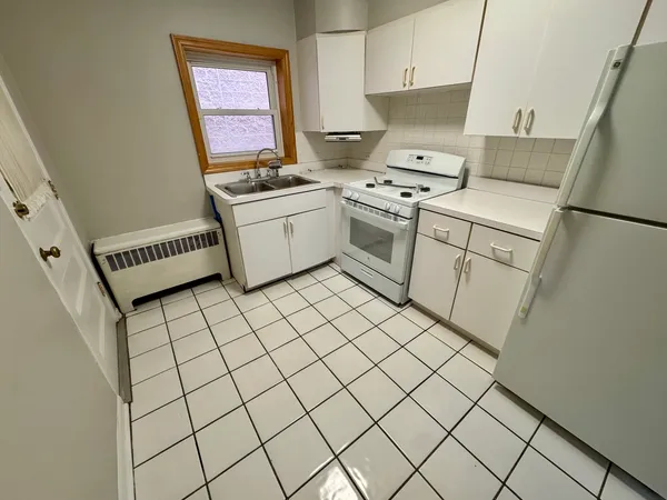 a kitchen with a stove a sink and a refrigerator