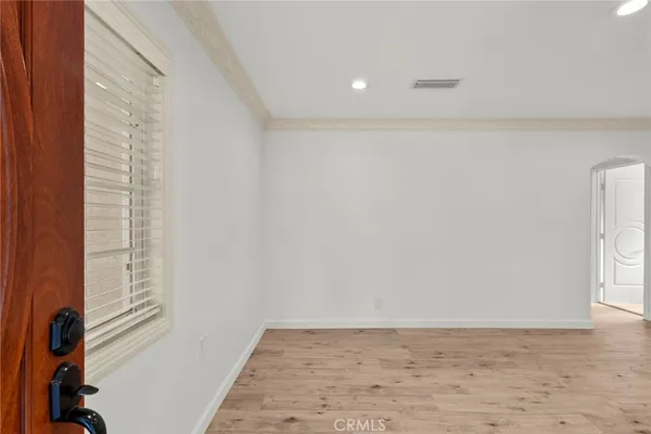 a view of wooden floor and windows in a room