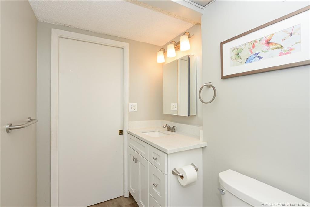 5373 Southeast Miles Grant Road, Unit C102 Stuart, FL 34997 - Photo 14 of 21 Nicely updated white shaker vanity.