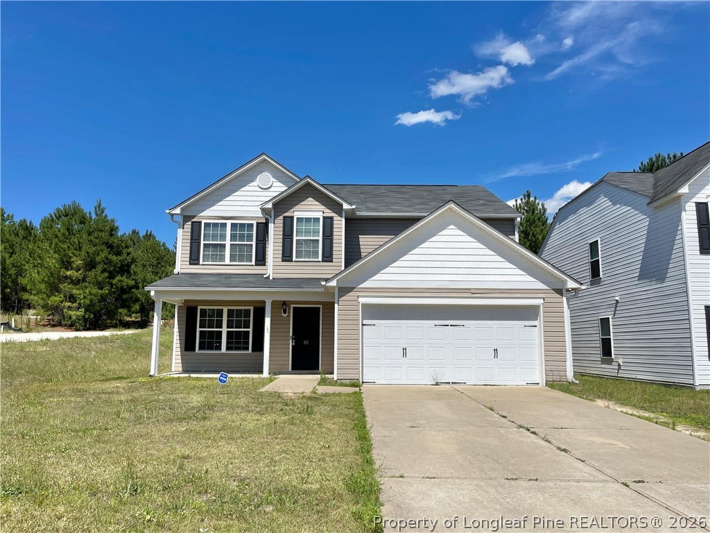92 Hallow Oak Street Spring Lake, NC 28390 - Photo 2 of 11 a view of a big house with a yard and garage