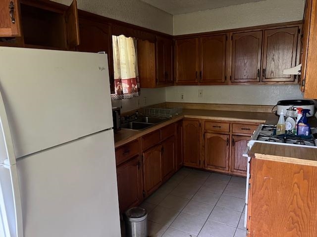 5067 Gill Road Memphis, TN 38109 - Photo 2 of 10 a kitchen with a refrigerator and a stove