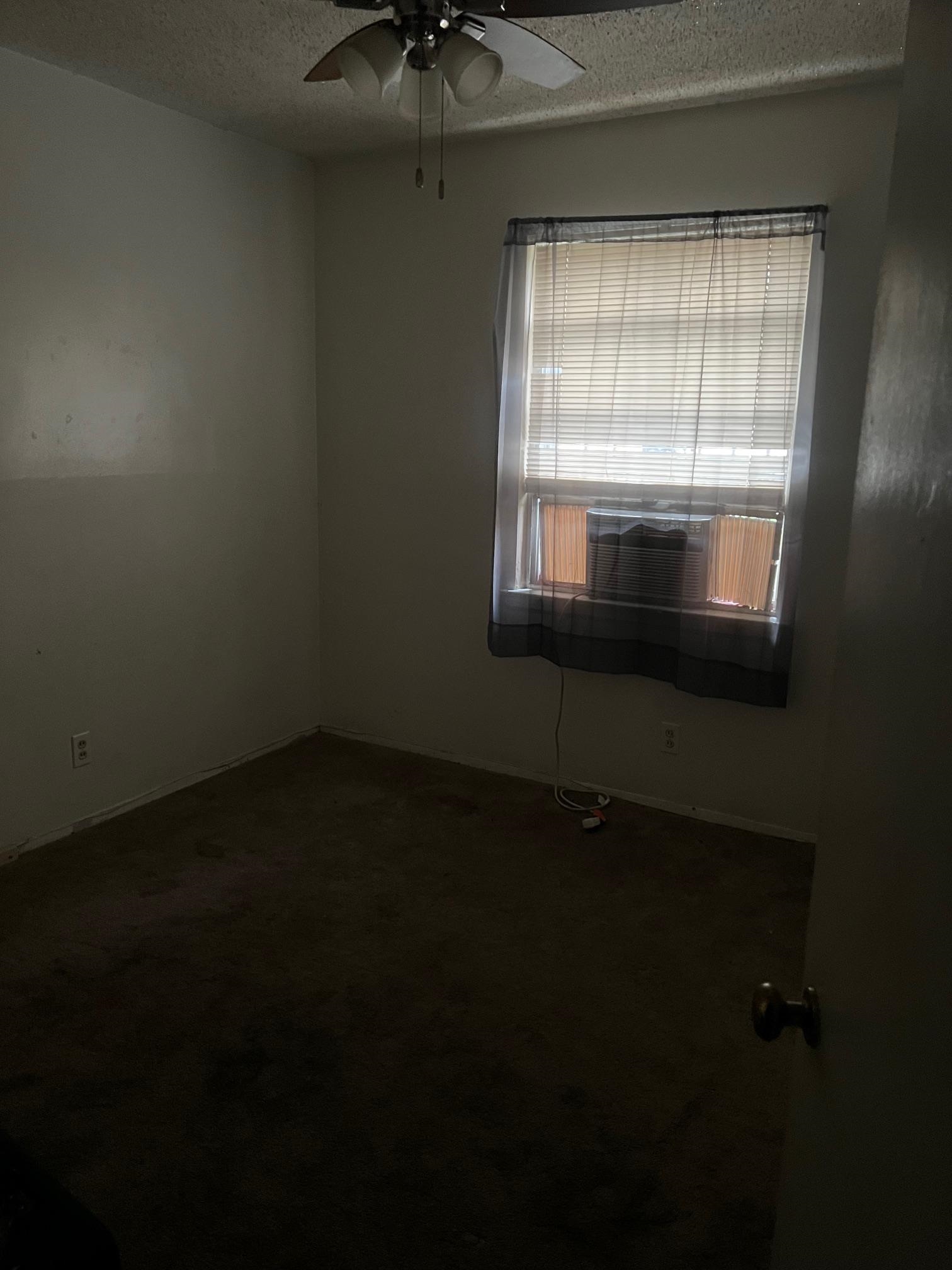 5067 Gill Road Memphis, TN 38109 - Photo 3 of 10 a view of an empty room with a window