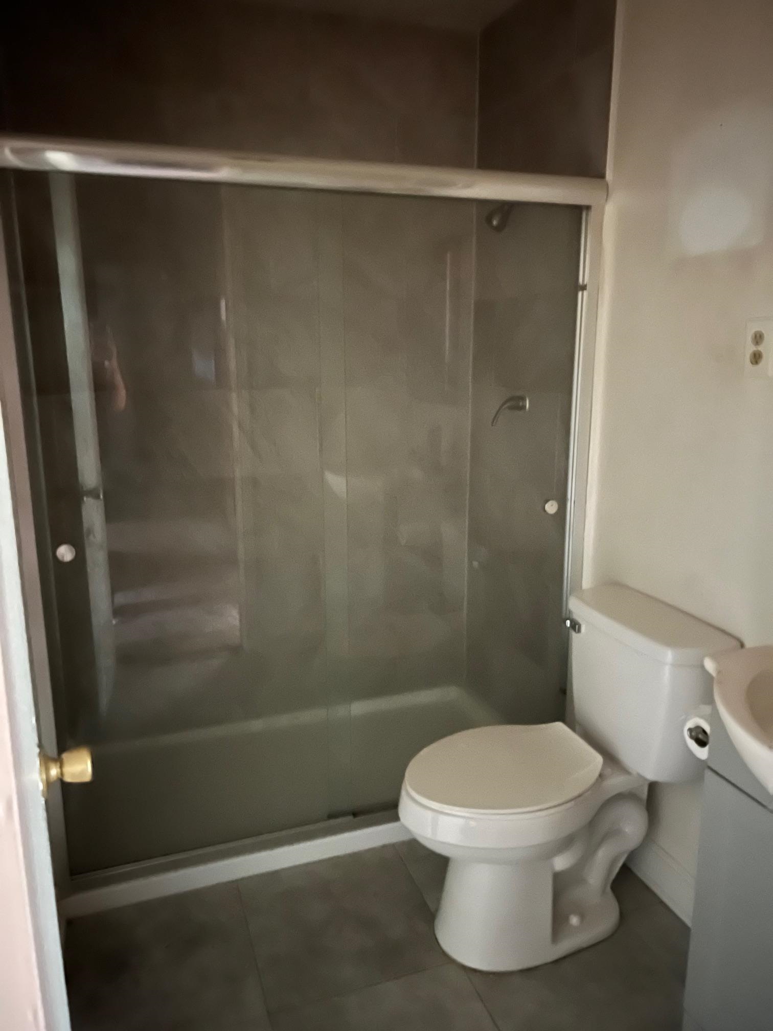 5067 Gill Road Memphis, TN 38109 - Photo 6 of 10 a white toilet sitting next to a bathroom sink