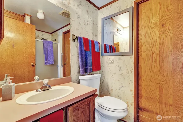 a bathroom with a sink vanity mirror and toilet