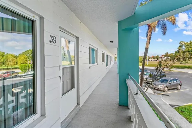 a view of a hallway with dining area windows and cabinet