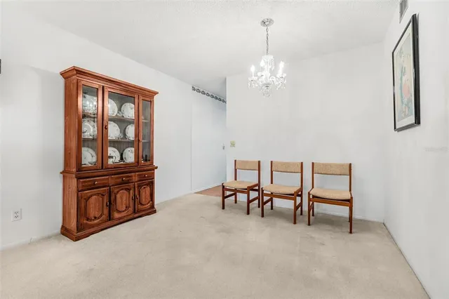 a view of a livingroom with furniture and chandelier fan