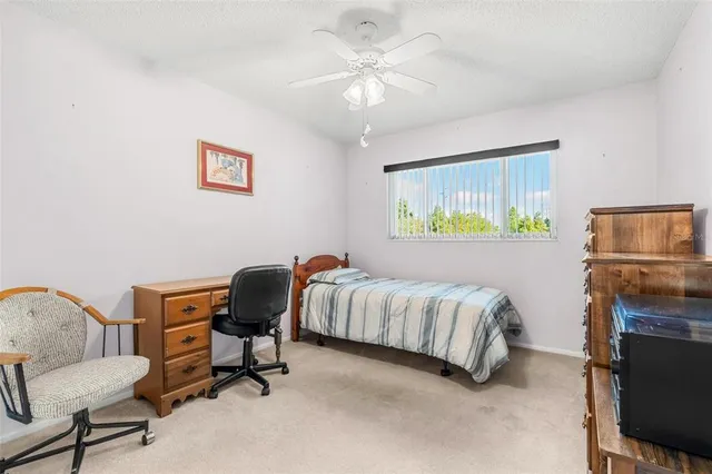 a bedroom with a bed and a chair