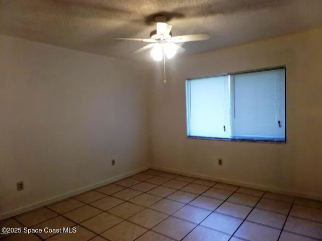 a view of a room with a fan and a window