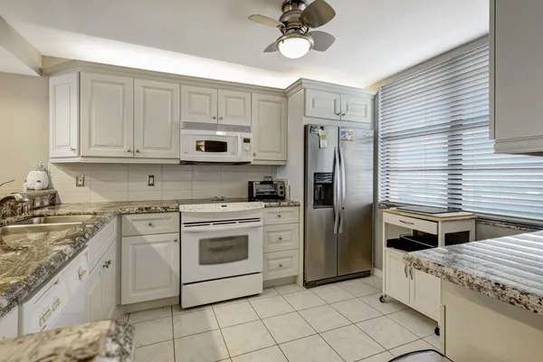 a kitchen with stainless steel appliances granite countertop a stove and a refrigerator