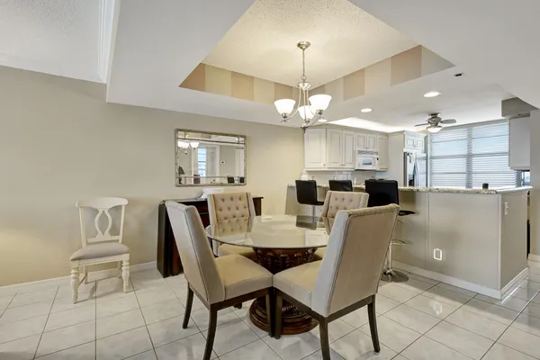 a view of a dining room with furniture and chandelier