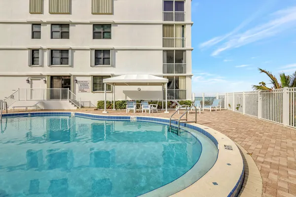 a view of a swimming pool with a lounge chairs
