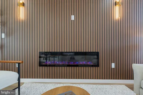 a dining room with stainless steel appliances kitchen island granite countertop a dining table chairs and a refrigerator