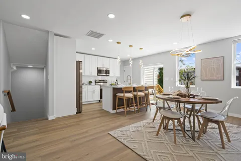 a kitchen with stainless steel appliances kitchen island granite countertop a sink and cabinets