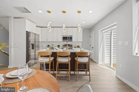 a kitchen with counter top space and wooden floor