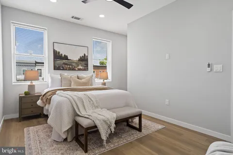 an empty room with a window and ceiling fan
