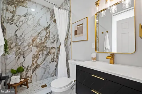 a bathroom with a shower and a sink