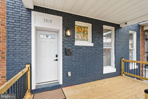 a view of entryway and dining room with wooden floor