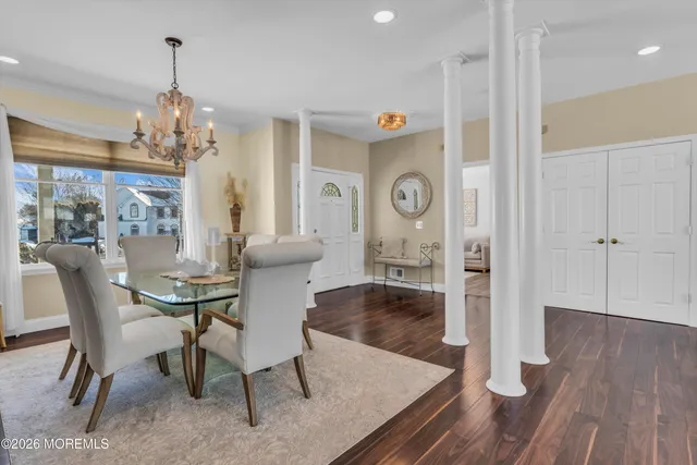 a living room with patio furniture and a flat screen tv