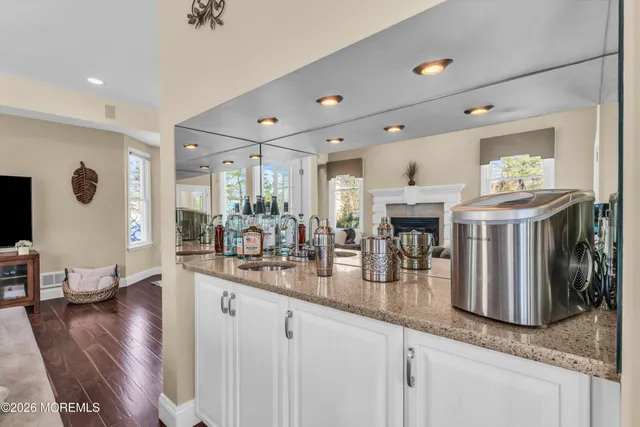 a living room with furniture a flat screen tv and a large window